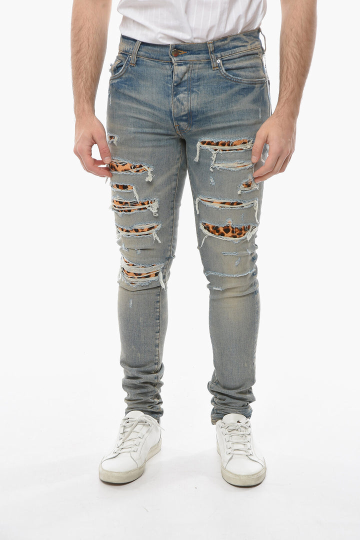 AMIRI SKINNY THRASHER DENIMS WITH LEOPARD DETAILS