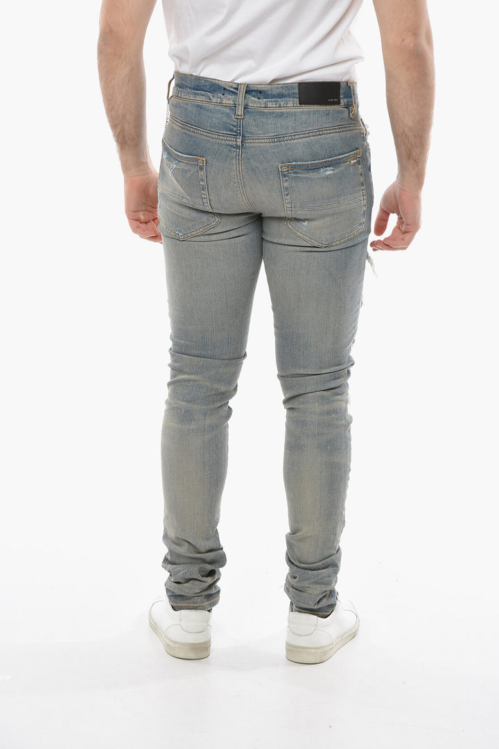 AMIRI SKINNY THRASHER DENIMS WITH LEOPARD DETAILS