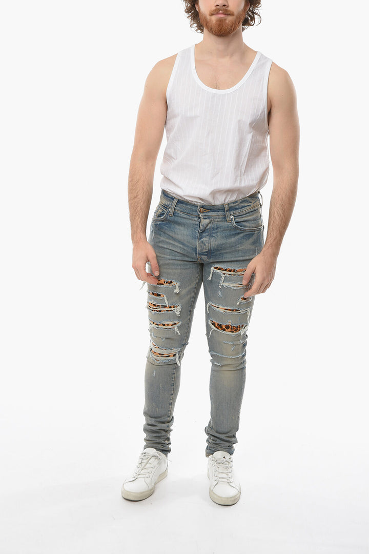 AMIRI SKINNY THRASHER DENIMS WITH LEOPARD DETAILS