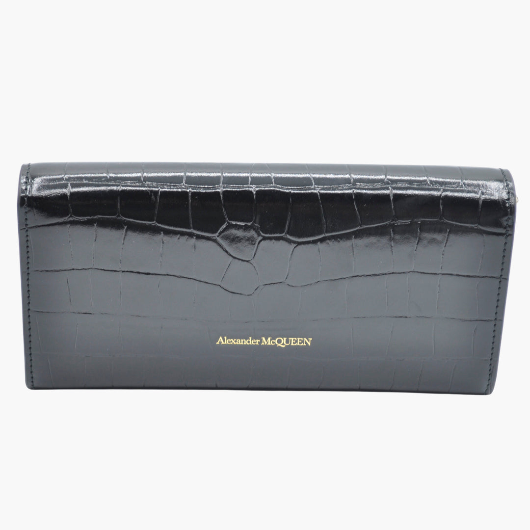 Portafoglio Alexander McQueen in pelle nera con stampa coccodrillo e motivo teschio dorato